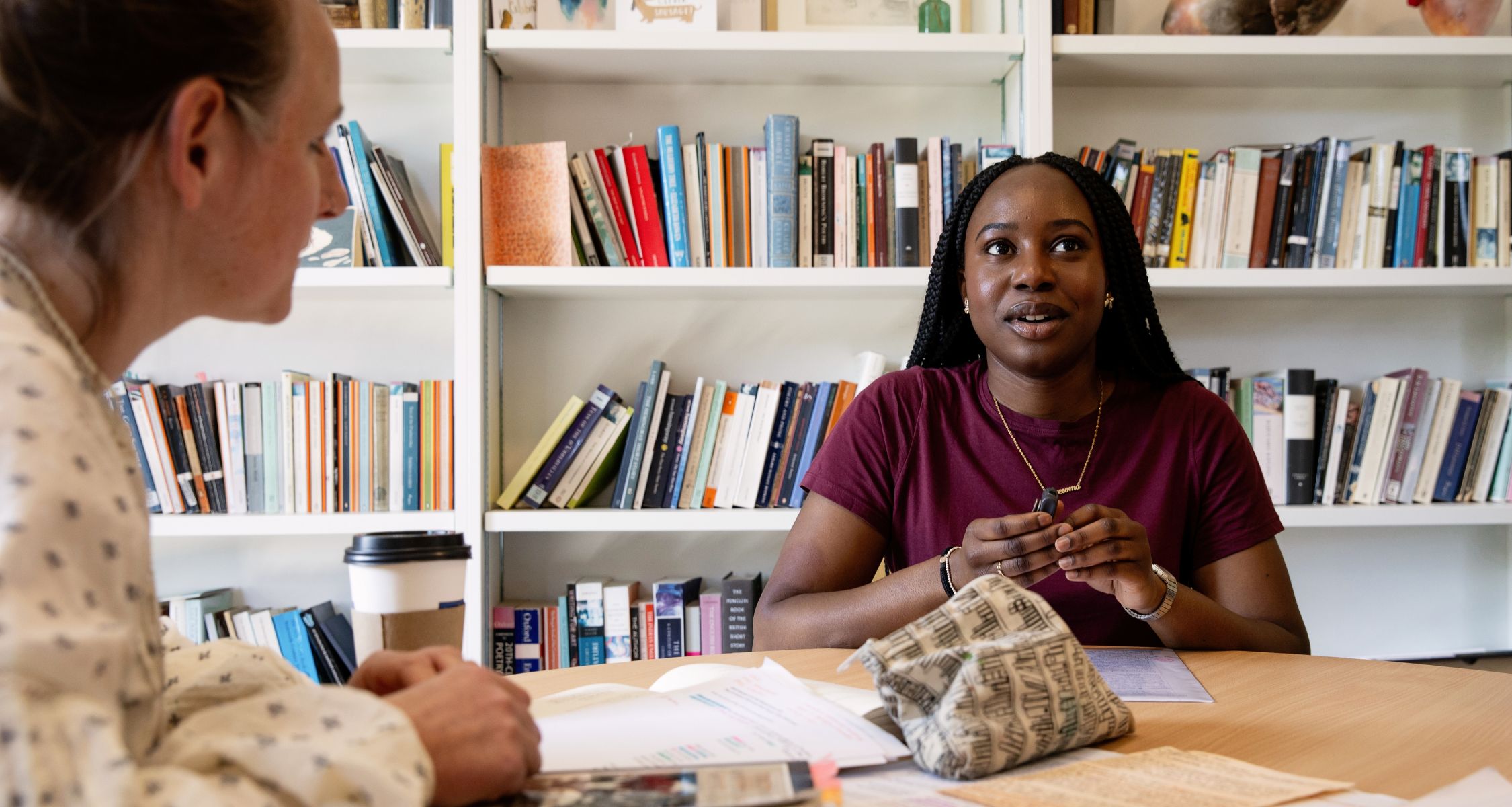 Fellow and students talking at a study supervision