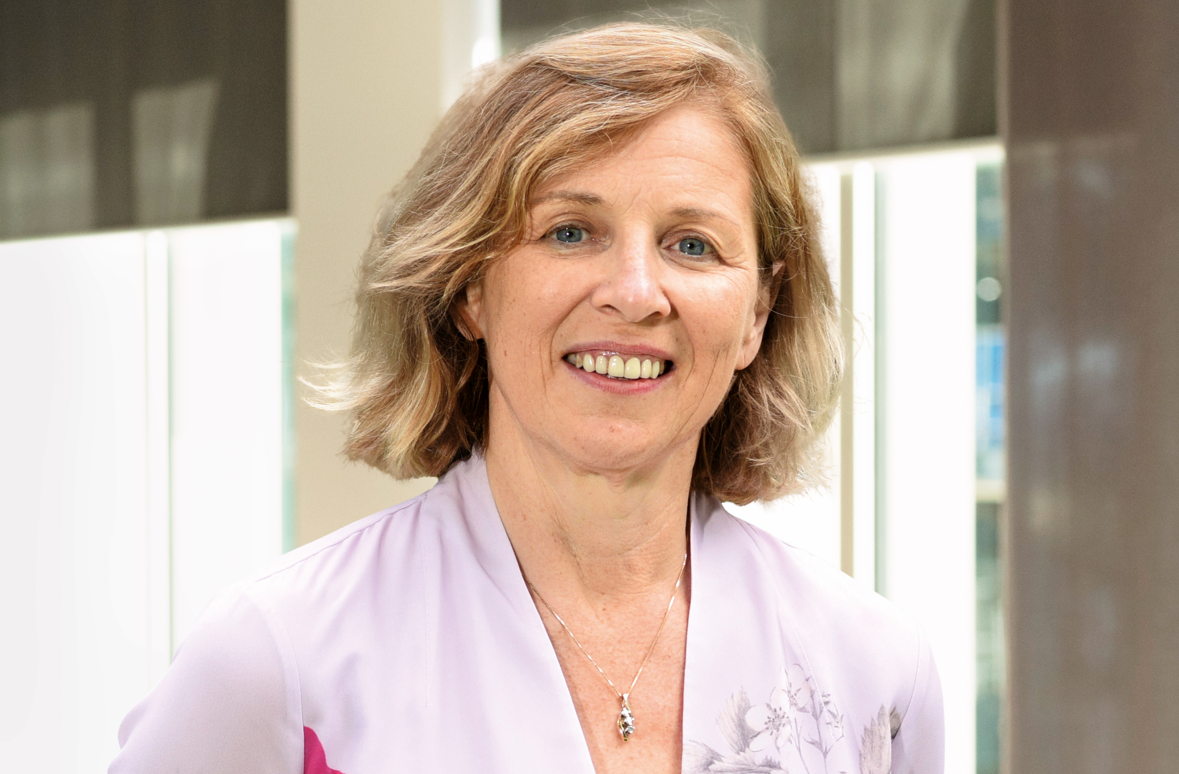A woman with blond hair smiling