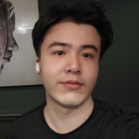 A young man with dark short hair looking at the camera.