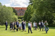 People on Garden Tour on Lawn in front of pond