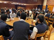 Groups of students sitting at round tables