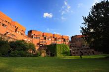A view on the red brick building of Robinson College from the college gardens